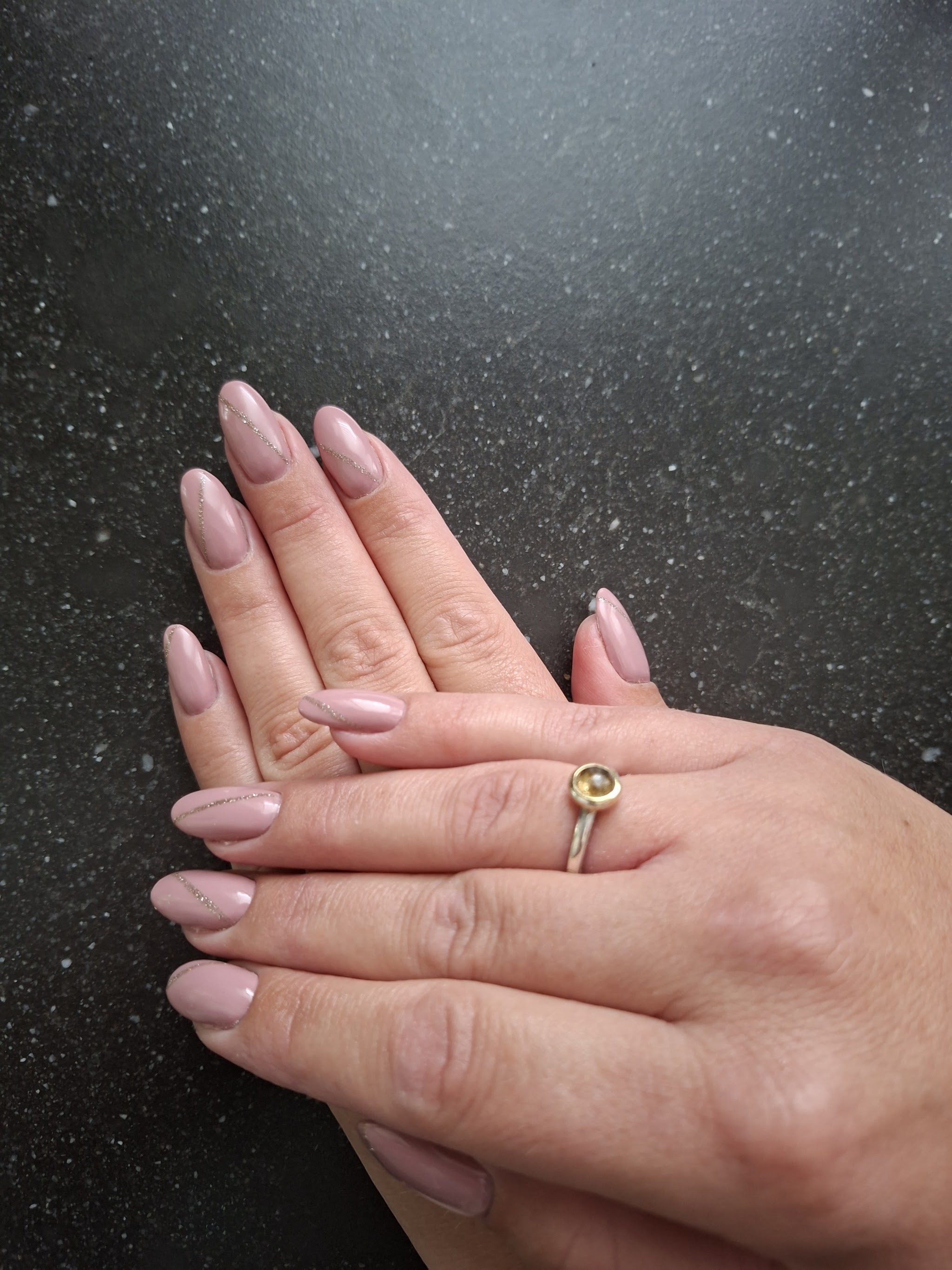 Mauve amandelnagels op een donker werkblad